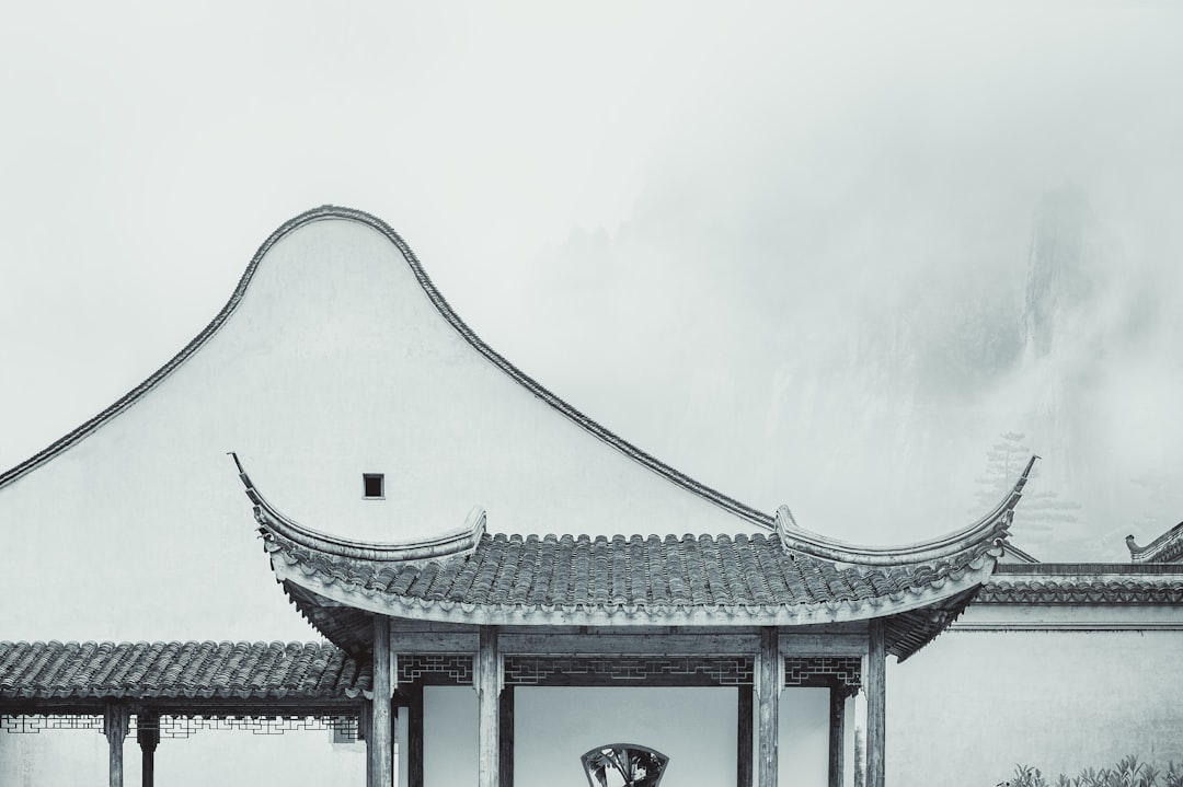 Traditional East Asian pavilion surrounded by greenery